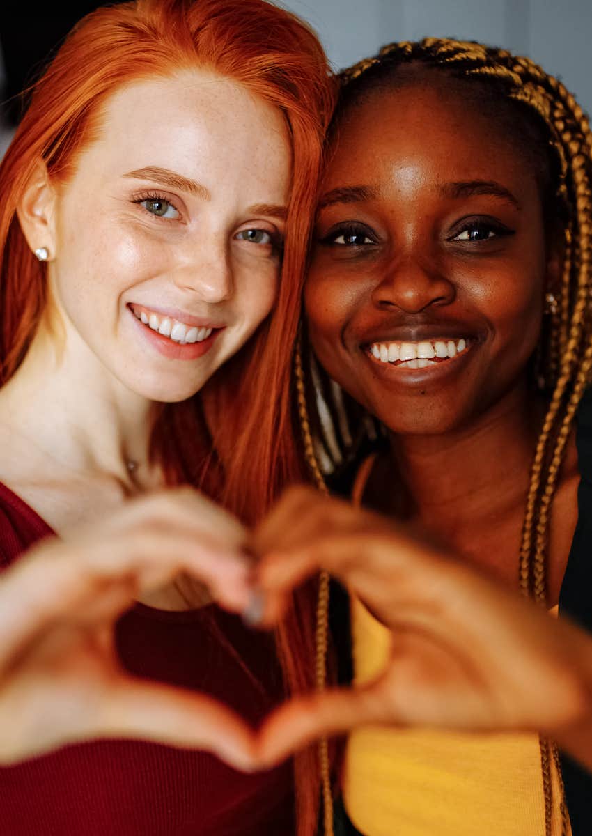 happy couple making heart hands