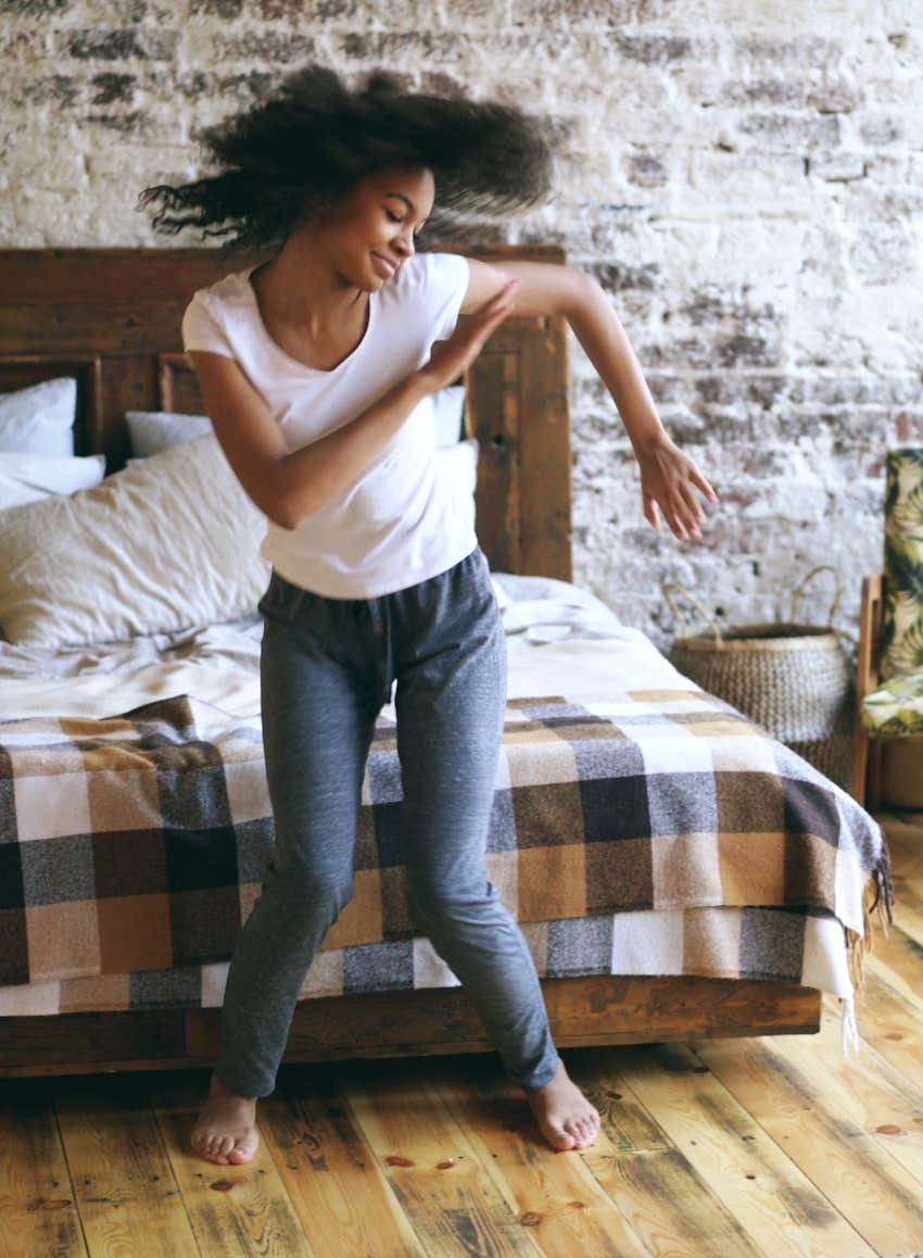 joyful woman having fun dancing at home